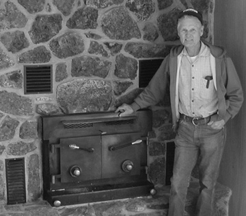 Mr. Tomsick in front of the Fireplace insert he designed and constructed for the Ranch house......